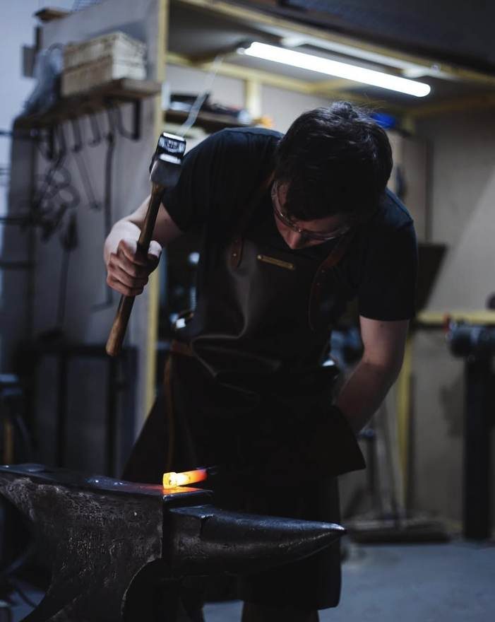 Sandy swinging a hammer at the anvil in the Newbridge forge